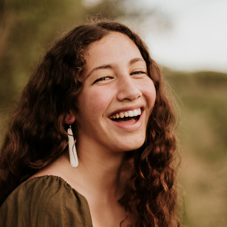 Model wearing plain drop earrings